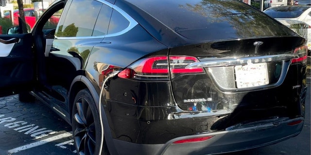 Tesla plugged into charging station, double parked in Vallejo CA