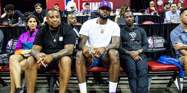 LeBron James and Rich Paul sit court side