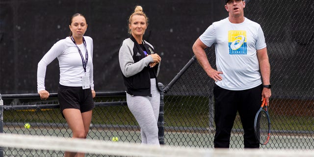 Yuliya Shupenia, Iris Harris, and Chris Tontz watch players