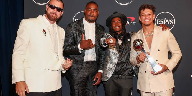 Travis Kelce, Chris Jones, Isiah Pacheco and Patrick Mahomes pose for a picture.