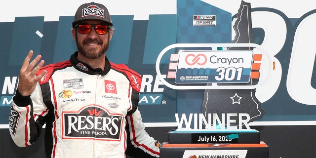 Martin Truex Jr. with trophy