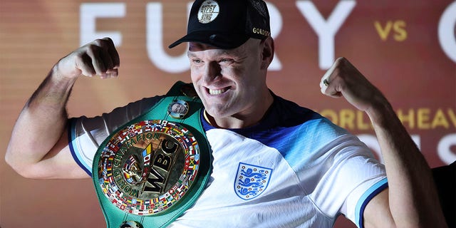 Tyson Fury poses with belt