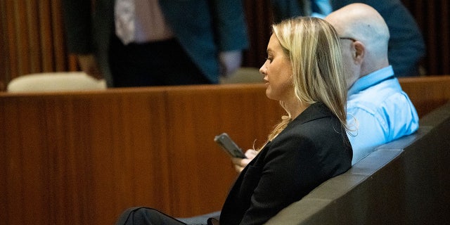 Dr. Katherine Roxanne Grawe sits during medical board hearing after having her license revoked