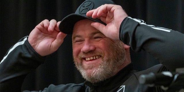 Wayne Rooney smiles at press conference