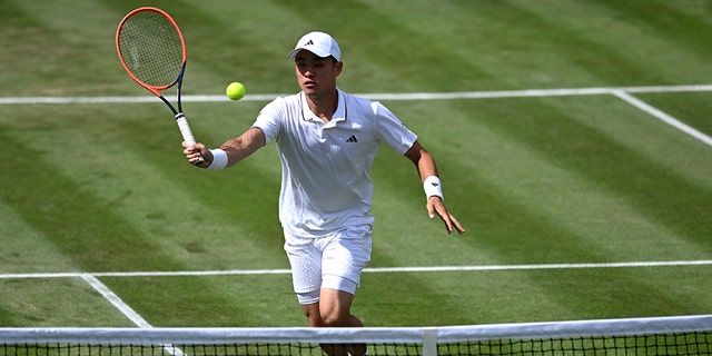 Yibing Wu plays during a men's singles match at Wimbledon