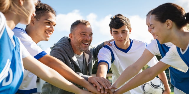 Coach with teen players