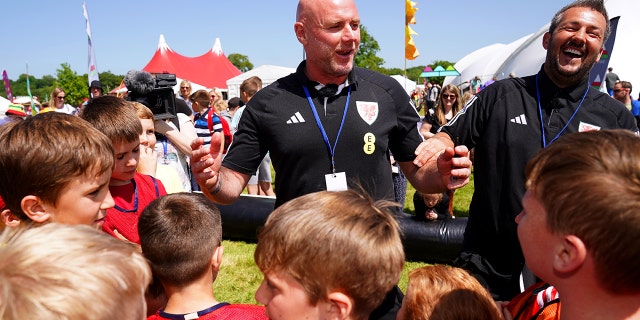A coach talking to kids on a sports team