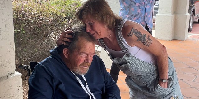Woman embraces her brother