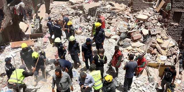 Rescuers search through wreckage