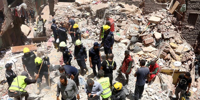 Rescuers search through wreckage