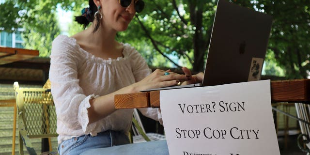 woman working while collecting signatures for petition