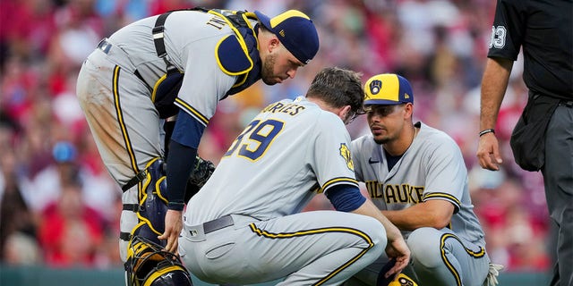Members of the Brewers check on Corbin Burnes