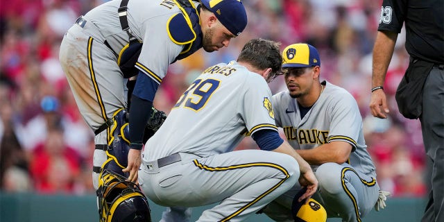 Members of the Brewers check on Corbin Burnes