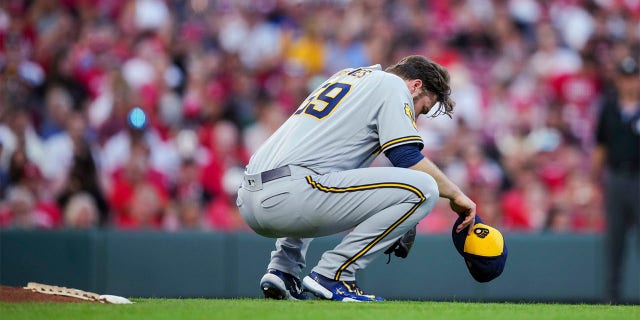 Corbin Burnes crouches behind the mound