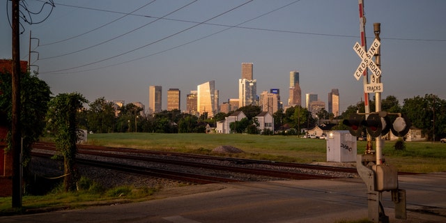 Downtown Houston, Texas, is seen behind railroad tracks