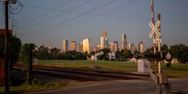 Downtown Houston, Texas, is seen behind railroad tracks