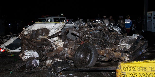 A mangled mass of steel lays at the site of a fatal collision in Kenya