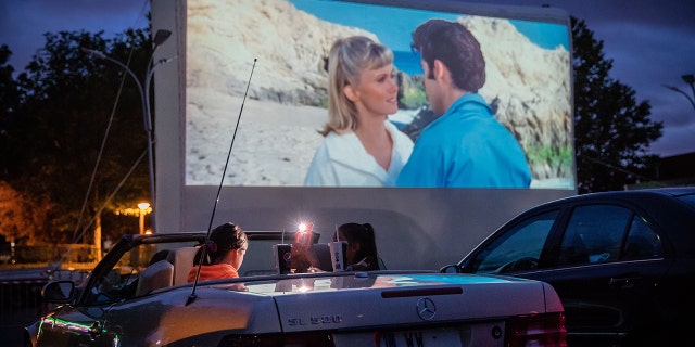 Cars watching a movie in a drive-in theater