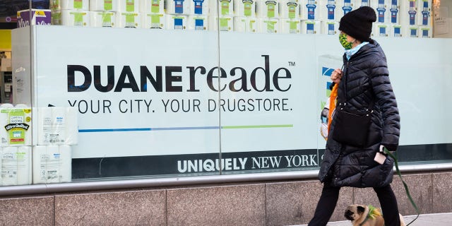woman walking past duane reade