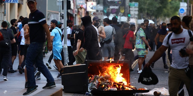 French protestors burning a trash can on the street.