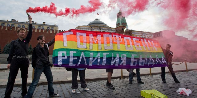 Gay rights activists hold banner
