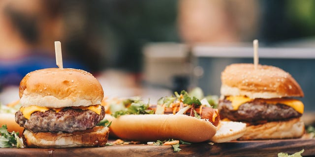 hamburgers and hot dogs on table