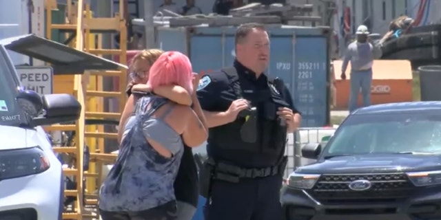 Women hugging outside of shooting scene