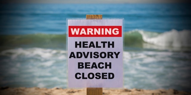 Beach advisory "Warning Health Advisory Beach Closed"