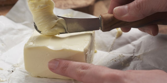 Person uses standard butter knife to cut butter.