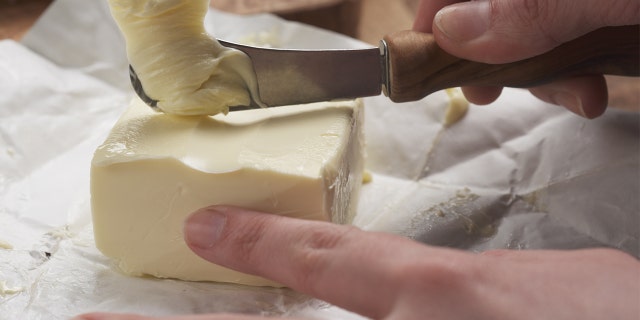 Person uses standard butter knife to cut butter.