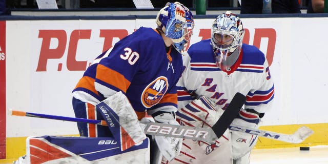 Igor Shesterkin and Ilya Sorokin warm up before an NHL in 2021