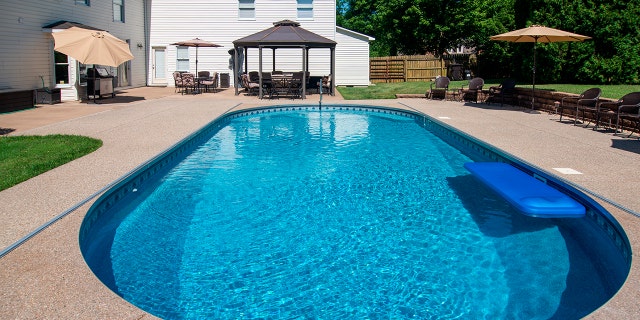An in ground pool in a backyard