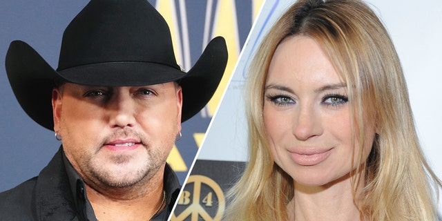 Jason Aldean in a black country hat split Izabella St. James smiles at the camera