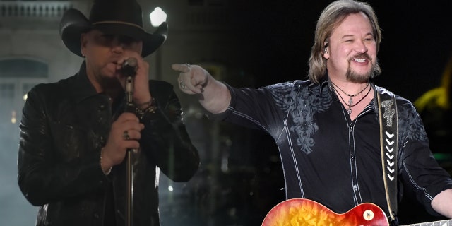 Jason Aldean singing, holding the microphone stand in "Try This In A Small Town" music video split Travis Tritt pointing with his right hand while on stage