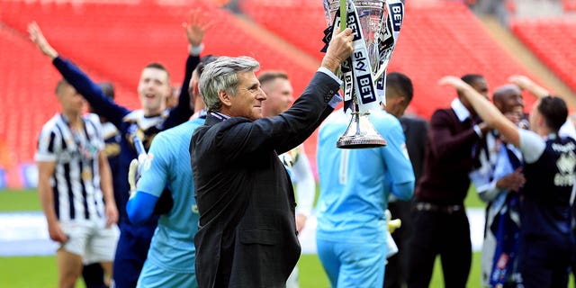 Millwall Chairman John Berylson holds a trophy