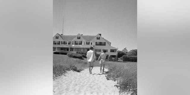 John F. Kennedy and Jackie walking towards the house in Hyannis Port
