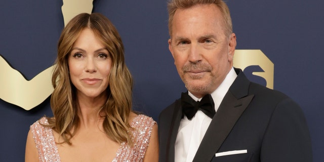 Kevin Costner and Christine Baumgartner walk red carpet at Hollywood event