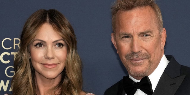 Kevin Costner and Christine Baumgartner walk red carpet