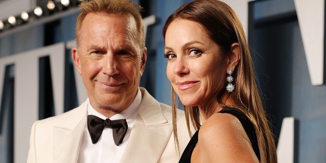 Kevin Costner wears white suit to Oscars after party with Christine Baumgartner