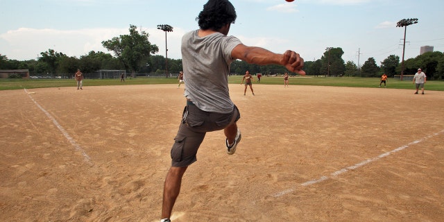 A person kicking a kickball