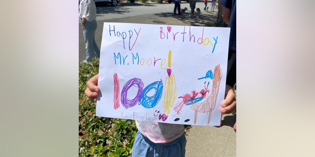 Kid holding happy birthday sign