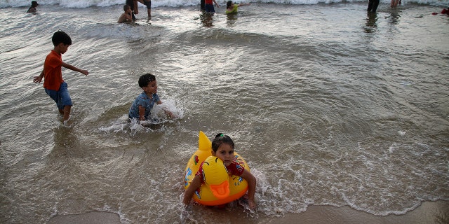 Kids playing in the water at the beach