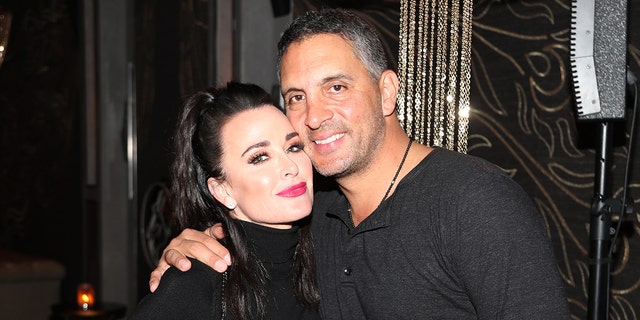 Kyle Richards and Mauricio Umansky hug at an event