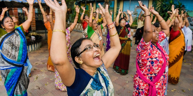 A group of people doing laughter yoga