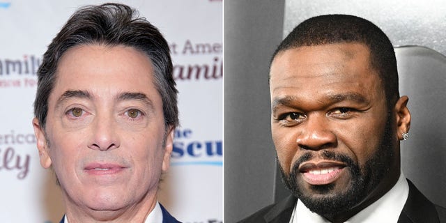 Scott Baio looks directly at the camera in a suit split 50 Cent smiles on the carpet