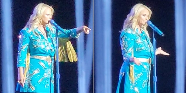 Miranda Lambert in a blue dress with fringe points to the crowd split Miranda Lambert puts her arms out on both sides with palms up