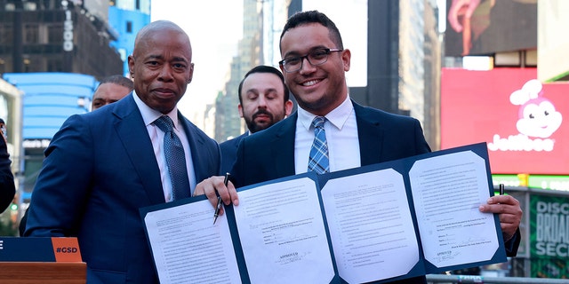 NYC Mayor Eric Adams and City Councilman Shaun Abreu hold up bill making Times Square a gun free zone