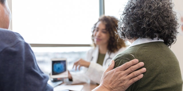 Older couple with doctor