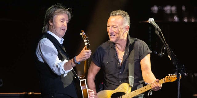 Paul McCartney performing with Bruce Springsteen