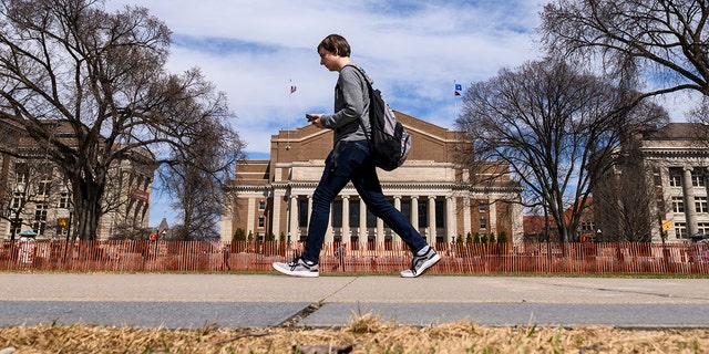 A pedestrian walks at the University of Minnesota campus